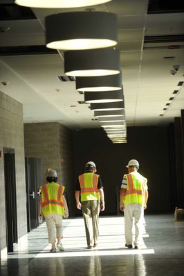 
                               
                                  Photo by Andy Shupe&mdash;
                               
                           
                           Officials walk through the hallways Thursday, Aug. 3, 2012, during a tour of the additions to the Fayetteville High School building.