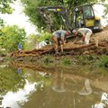 Johnny Kinard, center, and Joshua McDonald, right, workers with Southern Excavation in Fairhope, Ala...