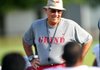 Arkansas Democrat-Gazette/MICHAEL WOODS  --08/07/2012-- University of Arkansas Head Coach John L Smith works with his team during practice Tuesday in Fayetteville.