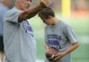 Fayetteville assistant coach Joe Thoma works Thursday, Aug. 2, 2012, with sophomore kicker James McMahan during practice at Harmon Field.
