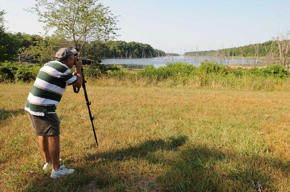 Terry Stanfill of the Decatur area photographs birds along the Eagle Watch Nature Trail. Stanfill is a dedicated steward of the trail who organizes activities there for a variety of troups.