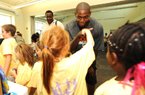 New York Knicks guard Ronnie Brewer (Fayetteville, Arkansas Razorbacks) greets students Thursday as they line up to receive school supplies at the Fayetteville Boys and Girls Club. Current members of the Arkansas men’s and women’s basketball teams also were on hand to distribute school supplies to students. Video available at arkansasonline.com/videos.