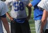Mike Ulloa, left, an offensive lineman, and Rogers coach Rob Bray workout in practice on Tuesday.