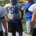 Mike Ulloa, left, an offensive lineman, and Rogers coach Rob Bray workout in practice on Tuesday. 