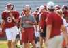 Arkansas quarterback Tyler Wilson (left) had four touchdown passes in Saturday’s scrimmage, but Razorbacks Coach John L. Smith (right) said the defense is improving. 