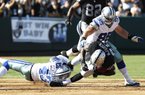 Dallas defensive back Gerald Sensabaugh (left) and defensive lineman Sean Lissemore tackle Oakland Raiders running back Darren McFadden (Pulaski Oak Grove, Arkansas Razorbacks) on Monday during the Cowboys’ 3-0 exhibition victory.