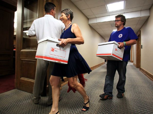 emily-williams-and-brian-hill-help-deliver-boxes-of-signatures-to-the-secretary-of-states-office-monday-aug-13-arkansans-for-compassionate-care-collected-74406-signatures-to-try-to-ensure-the-2012-arkansas-medical-marijuana-act-is-on-the-november-ballot