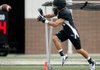 Gavin Shadrick, a Bentonville High School defensive back, runs through drills Wednesday during practice inside Tiger Stadium.