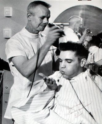 
                           No. 4: "Heartbreak Hotel"
Released in January 1956, "Heartbreak Hotel" was Elvis' first No. 1 record on the Billboard pop charts, and the single was the best-selling that year. Rolling Stone ranked the song No. 44 on its list of The 500 Greatest Songs of All Time.

***

James Peterson begins to cut Elvis Presley's hair at Fort Chaffee in March 1958 during Presley's induction. Another barber at Chaffee, Fred Kinslow, said Presley quipped as he blew locks of his hair away, "Hair today, gone tomorrow."

Courtesy of Fred Kinslow