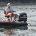 Grimsley Graham catches a white bass while fishing with his friend Bob Ross near Brashers' boat. 