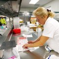 Jean Hill looks over menus Thursday inside the new cafeteria at Fayetteville High School. Cafeteria ...