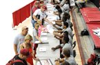Thousands of fans lined up to get autographs from the Arkansas football team, including the linebackers seen here, during Saturday’s fan day at Walton Arena in Fayetteville. Arkansas officials estimated the crowd at Saturday’s scrimmage at 15,000. 