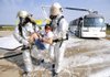 STAFF PHOTO MARC F. HENNING
Firefighters carry Ana Beth La Tour, 13, of Fayetteville to a triage area Saturday, Aug. 18, 2012, during the Tri-Annual XNA Full-Scale Exercise at Northwest Arkansas Regional Airport in Highfill. The multi-agency training exercise simulated an MD-80 passenger airliner crash and included around 50 volunteers from Benton County 4-H and the Civil Air Patrol who played the role of victims.