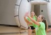Emily Coats of Springdale Har-Ber sets the ball Thursday as Caroline Webb, back, watches during the game against the Lady Panthers of Siloam Springs at Bentonville High School during the Teen Cancer Challenge.