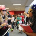 Lingle eighth-grade students Maddi Ware, left, and Selana Ramirez sport flower-girl outfits while le...