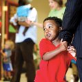 Tavian Daniels, 4, holds tightly on to his father, Todd Daniels, both of Rogers, Monday inside Shilo...