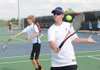Rogers High School tennis players Austin Wright, left, and Andrew Jones practice Wednesday at the school’s tennis courts.