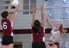 Mariah King, left, and Gabriela Aldaco, center, of Springdale try to block a hit by Shiloh Christian’s Emily May on Tuesday at Springdale.