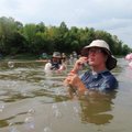 Cindi Duda of Illinois blows bubbles during a swim break with her husband, Brian, left.