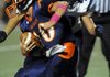 Jordan Kontz, right, of Springdale Har-Ber closes in on Rogers Heritage quarterack Josh Qualls during their Oct. 14 game at Gates Stadium in Rogers.
