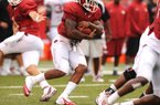 Arkansas running back Knile Davis (center), who was averaging 99.9 yards a game before he tore a ligament in his left knee last season, is one of several SEC running backs making a comeback from significant injuries.
