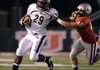 Tearris Wallace, left, Bentonville running back, stiffarms Tulsa Union linebacker David Todd on a carry during the Tigers’ scrimmage Friday against the Redskins at Union-Tuttle Stadium in Tulsa, Okla. 