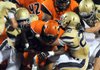 At left, Shiloh Christian senior Mitchell Griffith (left) and junior Nick Gookin (right) tackle Warren’s Kilay Cox during Monday’s game at Estes Stadium in Conway. Cox rushed for 304 yards on 23 carries. Shiloh Christian scored twice in the final five minutes to win the game. 