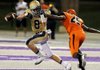 Warren sophomore Calyx Harris (right) knocks the ball out of Shiloh Christian sophomore Ben Olsen’s hands during the first half on Monday night at Estes Stadium in Conway. 