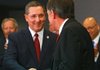 New Arkansas State Police Director Stan Witt (left) is greeted by outgoing director J.R. Howard as Witt takes the podium to address the crowd at Arkansas State Police headquarters Monday afternoon in Little Rock.

