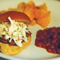 Slow-Cooker Barbecue Pork is an easy recipe to make the night before a tailgate party. Canned cola i...