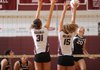 Kaylie Pendergrass, right, a Springdale junior, reaches to send the ball past Huntsville junior Cara Cagle, middle, and senior Rose Robinson on Tuesday during play at Springdale High.