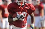 NWA Media/ANDY SHUPE -- Arkansas running back Nate Holmes carries the ball Saturday, Aug. 11, 2012, prior to the start of the Hogs' scrimmage in Razorback Stadium.