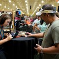 Bay Phommachak, right, gets an autograph Thursday from Corey Cogdell during the opening of the Cabel...