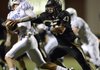 John Donald, left, a Bentonville linebacker, chases down Kansas City (Mo.) Rockhurst quarterback Trey Vickers during the fourth quarter of the Tigers’ season opener at Tiger Stadium in Bentonville. The Tigers travel to Broken Arrow, Okla., on Friday.