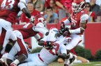 Arkansas defensive back Tevin Mitchel pulls down Jacksonville State running back DaMarcus James on Saturday night. 
