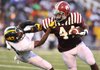Pine Bluff fullback Kelvin Sergeant (right) stiff-arms Watson Chapel cornerback Jordan Stargell during the first quarter of Friday night’s game. The Zebras scored 48 first-half points en route to a 48-12 victory. 