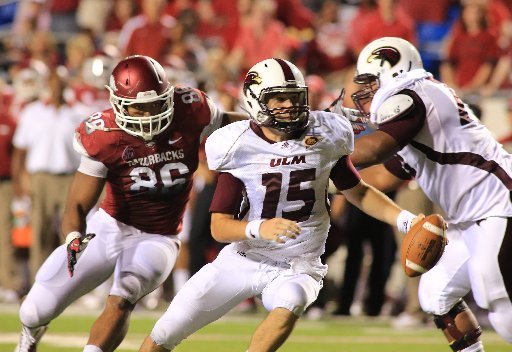 arkansas-democrat-gazetterick-mcfarland-090812-louisana-monroe-qb-kolton-browning-scrambles-away-from-arkansas-trey-flowers-in-their-game-at-war-memorial-stadium-in-little-rock-on-saturday