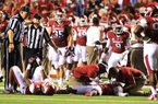 Arkansas cornerback Tevin Mitchel is attended to after taking a hard hit during the fourth quarter of Saturday’s game against Louisana-Monroe at War Memorial Stadium in Little Rock. Mitchel was injured when he and linebacker Alonzo Highsmith had a helmet-to-helmet collision while making a tackle. Mitchel was immobilized and carted off the field. 