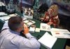 A job seeker meets with Addus HealthCare representative Julie Kalloway at a “Hire a Vet” job fair in Addison, Ill., on Thursday. The number of job openings fell in July, the Labor Department said. 