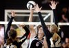 Mariah King, center, a Springdale junior, tries to send a shot past Bentonville sophomore Anna LeDuc, left, and sophomore Sabrina Shepherd during their match on Tuesday at Bentonville.