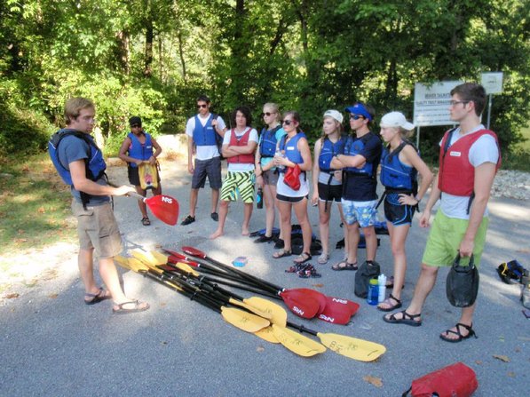
                           Staff member Keegan Evans offers paddling tips before students take off down the White River below Beaver Dam in kayaks.   