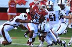 Arkansas Dennis Johnson runs up the middle in 1st quarter against Louisana-Monroe in their game at War Memorial Stadium in Little Rock on Saturday.