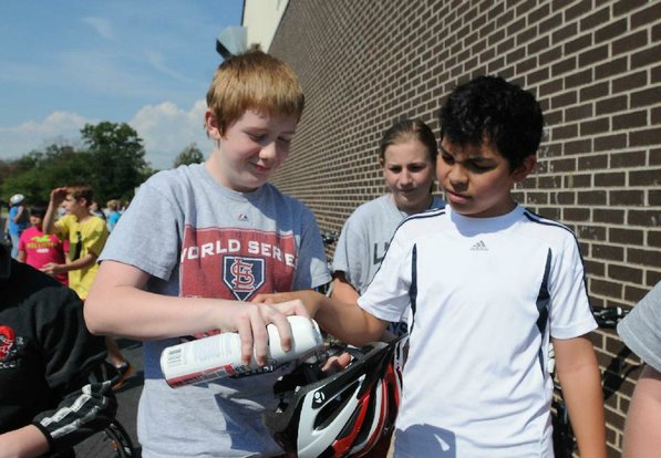 Chase Thurman cleans his helmet after training.