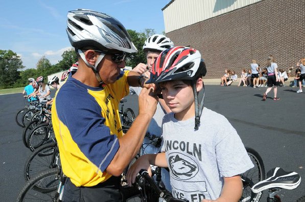 Falcon makes sure that Sam Lewis's helmet fits properly.