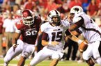 Arkansas defensive end Trey Flowers (left) chases Louisiana-Monroe quarterback Kolton Browning during the Razorbacks’ 34-31 overtime loss to the Warhawks last Saturday in Little Rock. 