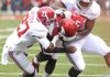 Arkansas quarterback Brandon Mitchell (17) is tackled by Alabama defensive back Nick Perry (27) and linebacker Xzavier Dickson during the first quarter. Arkansas was held to 137 yards of total offense during Saturday’s game. 