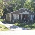 Police search a house Tuesday on Mission Boulevard.
