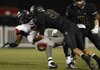 Jimmy Short, right, a Bentonville linebacker, lays a big hit on South Panola (Miss.) running back Darrell Henderson during the Tigers’ game Friday in Bentonville.