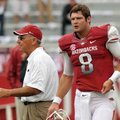 Arkansas Coach John L. Smith (left) and quarterback Tyler Wilson walk on the field before last Satur...