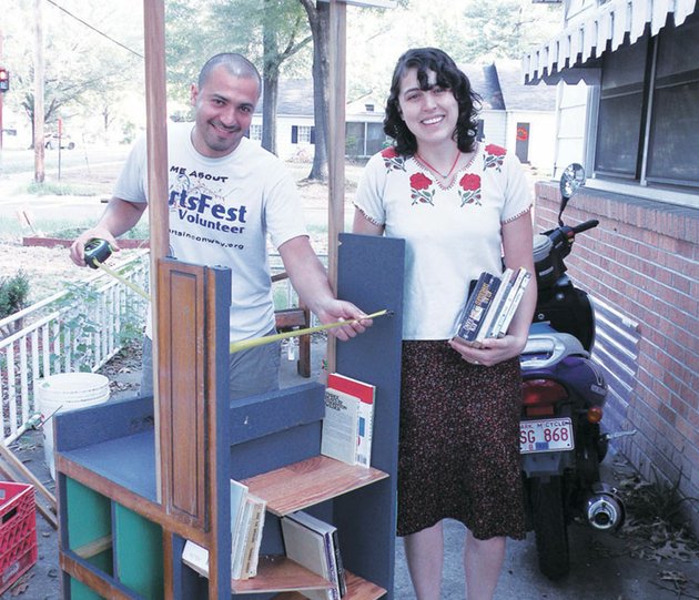hector-garcia-left-and-sandra-leyva-work-on-nomada-which-will-be-one-of-the-wayfinders-at-the-conway-artsfest-garcia-a-senior-art-major-at-the-university-of-central-arkansas-and-a-member-of-the-festivals-planning-committee-said-a-wayfinder-may-point-the-way-to-a-venue-at-the-arts-festival-or-may-be-an-event-itself-in-this-case-nomada-is-a-portable-library-that-the-two-artists-hope-will-be-utilized-throughout-the-community-following-artsfest-leyva-operates-the-lalucha-space-which-is-used-by-community-members-in-various-endeavors-including-art